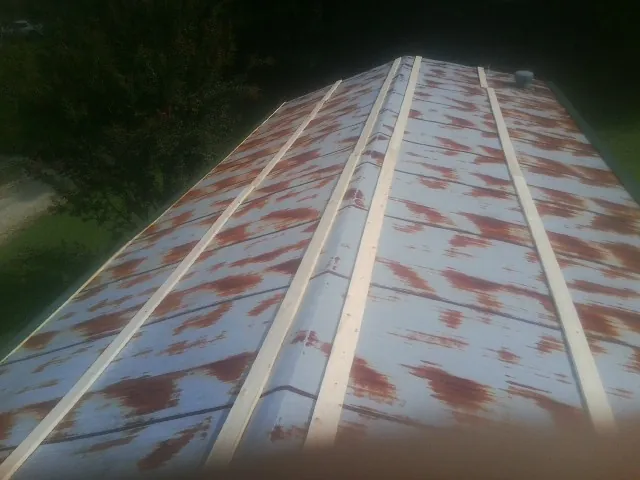 Rusted metal roof panels with new wood purlins before replacement — Storm Damage Roof Repair in Walkersville by Roofing Brothers