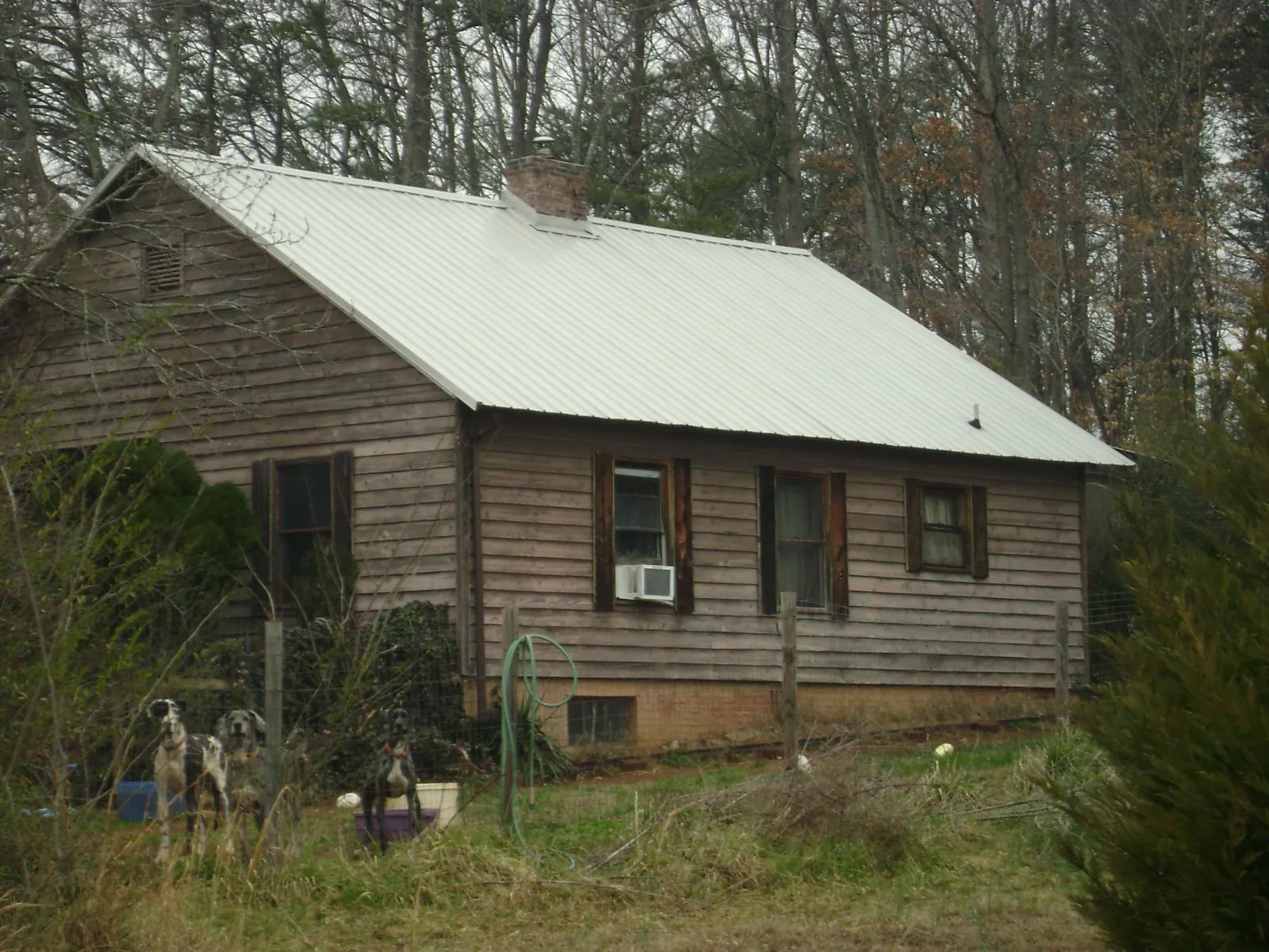 White metal roof on an old wood sided farmhouse, from a Metal Roof Installation job in Walkersville